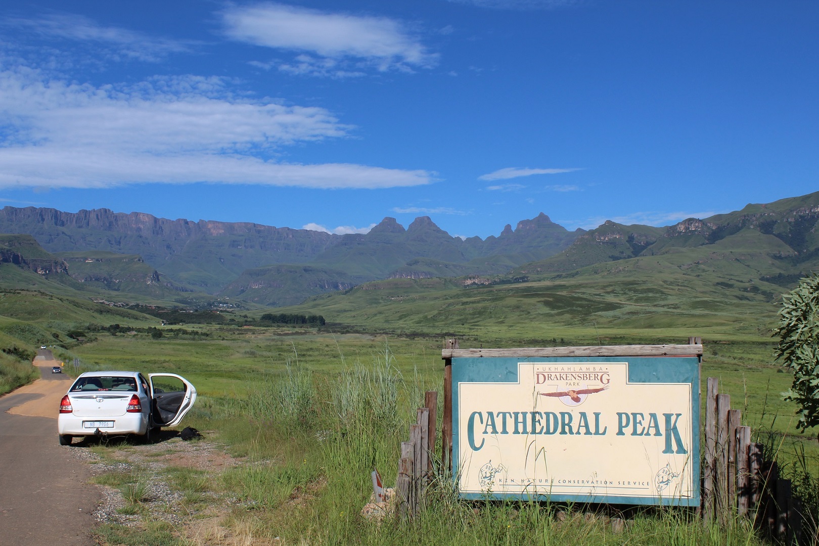 The start point of Cathedral Peak hike was couple of kilometers ahead of this sign at a local hotel. The Cathedral Peak is the sharp on the right from the three high peaks. Picture: Chris Hanson.