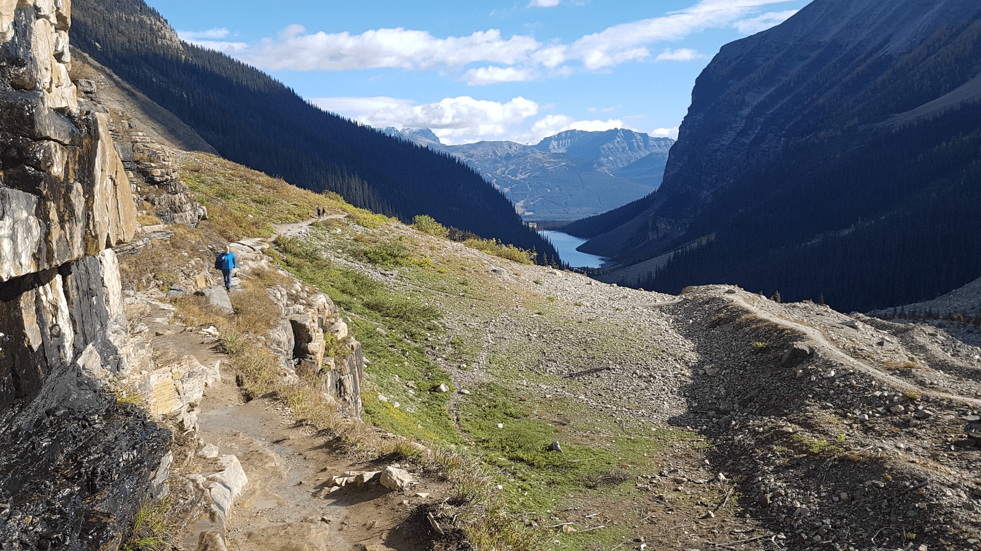Hiking trail to mountain hills from Lake Louise. The lake is visible at the background.