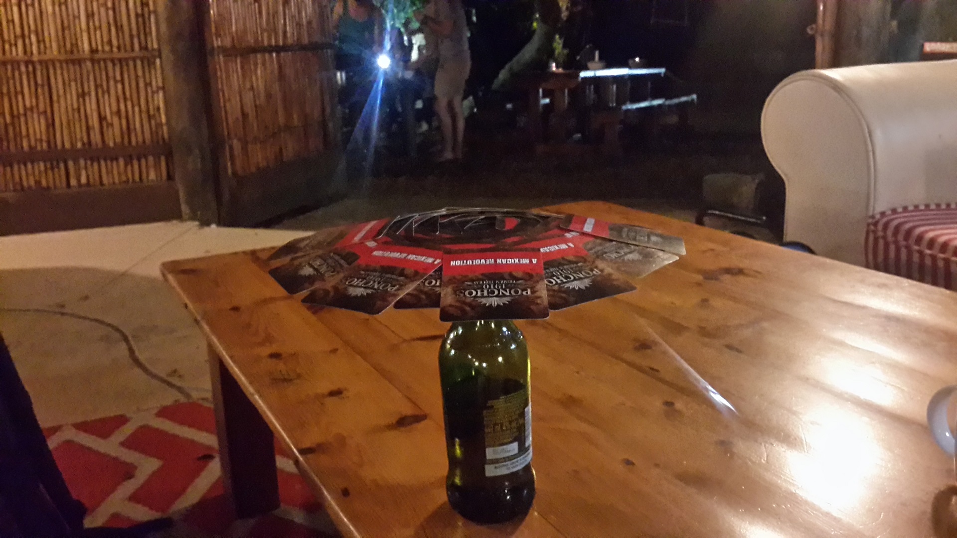 Umbrella drinking game. The first card is balanced on top of an empty bottle after which each player sets a card so that two corners can't touch existing cards. Players can settle a punishment for a player who screws up. In the picture whole deck of cards makes the umbrella. Don't be confused from the beer as I have drank only 12 portions of alcohol during four months.